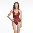 Woman wearing a red lace lingerie set on a white background