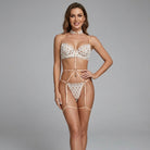 Woman wearing a white lace lingerie set on a gray background
